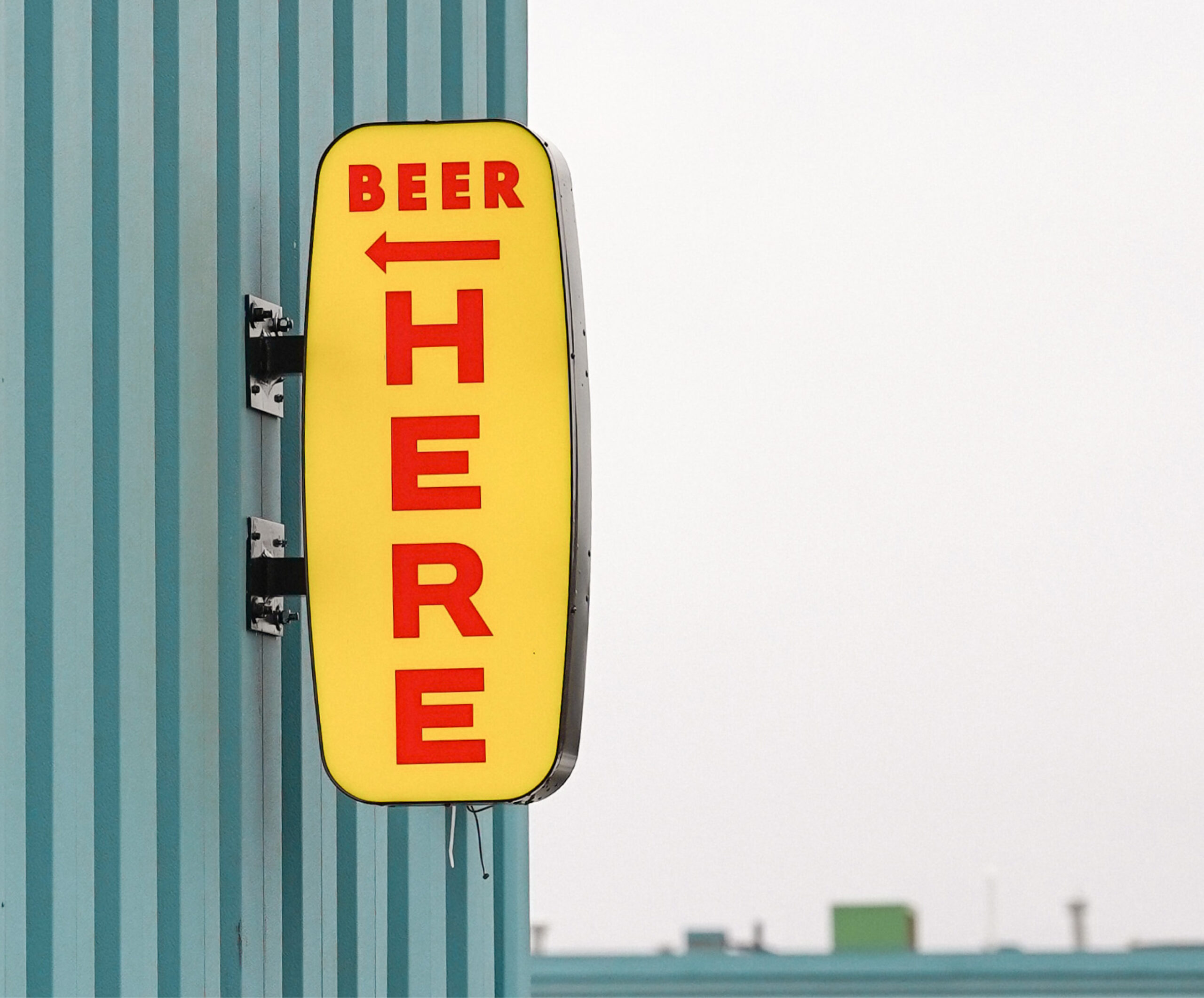 Dominion City "Beer Here" signage on outside of brewery.