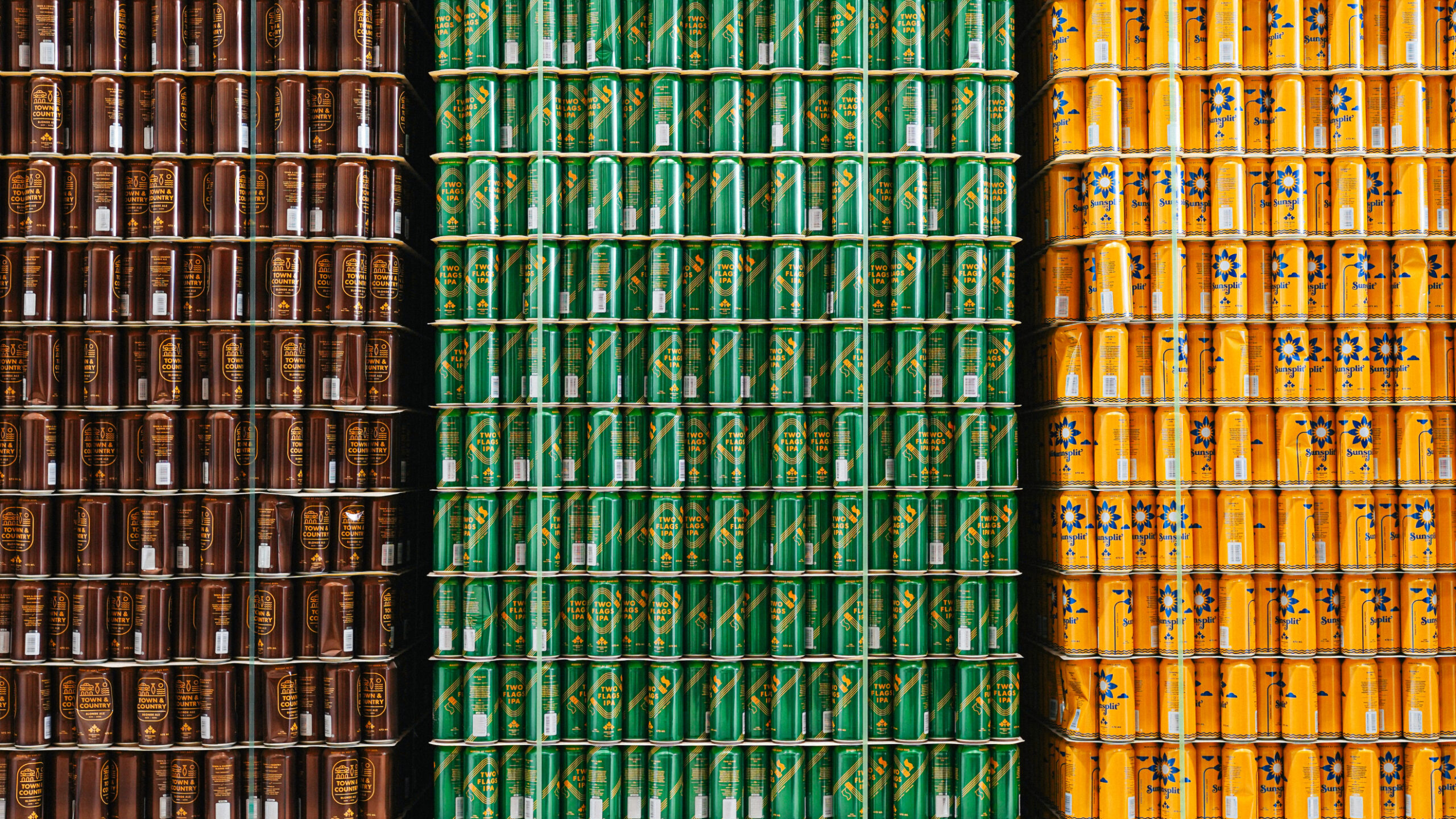 Dominion City mainstay beers stacked in a warehouse.