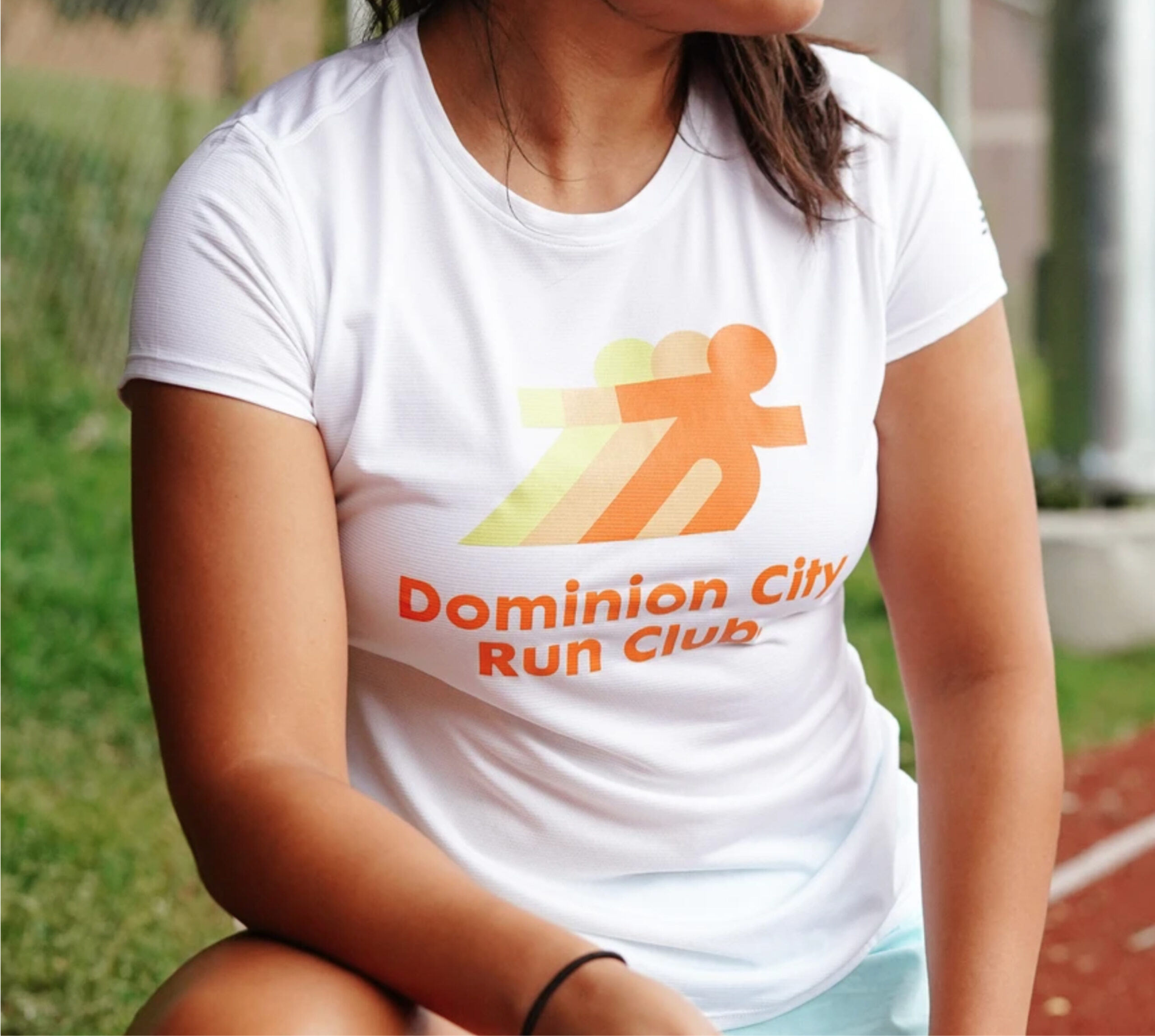 Woman wearing a retro-style Dominion City Run Club t-shirt.
