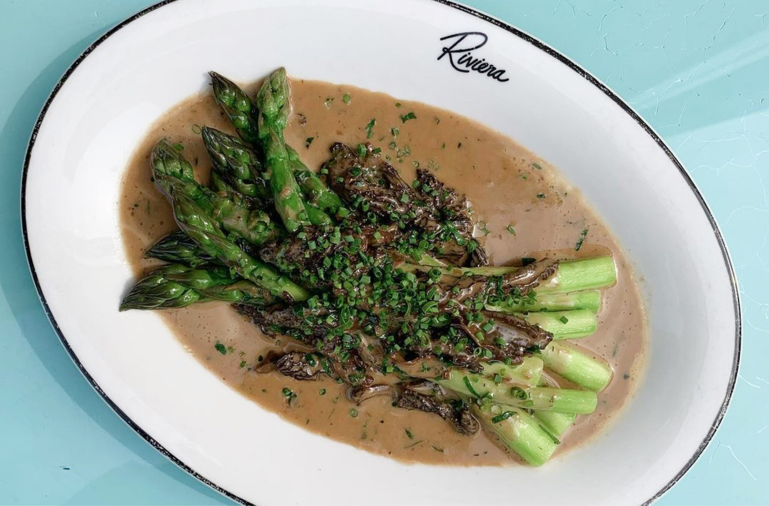 Riviera branded oval plate with asparagus.