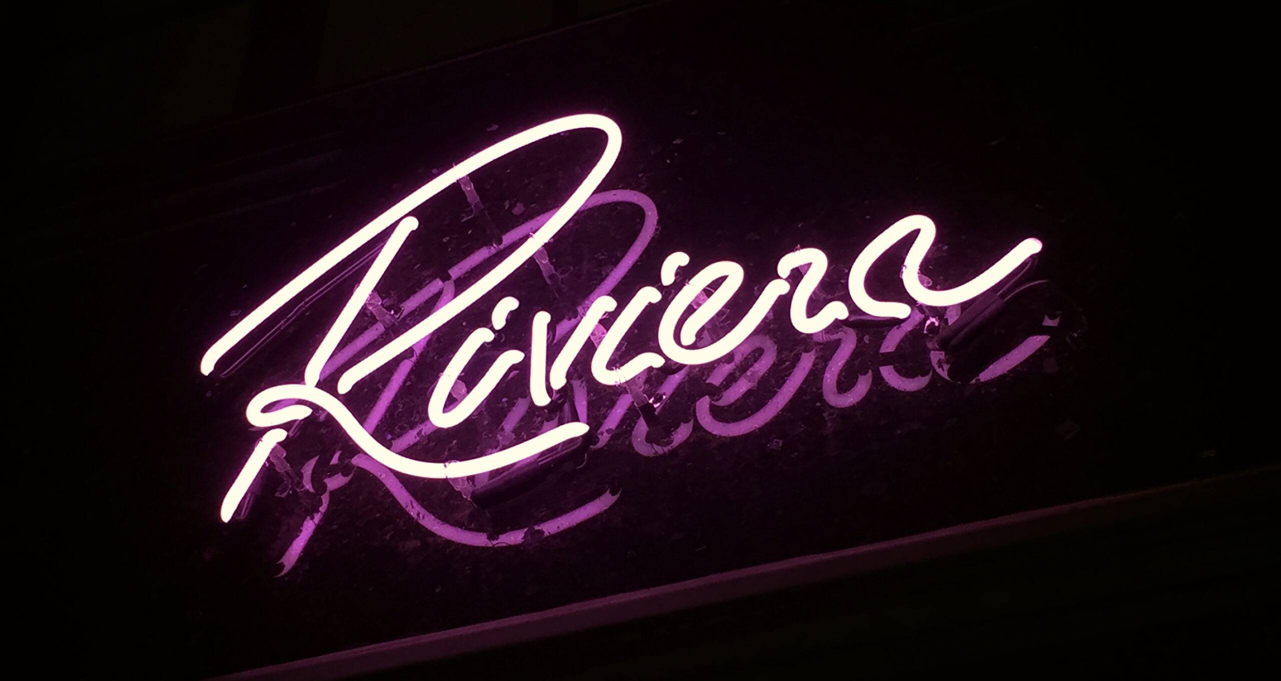 Close up of Riviera neon logo sign.
